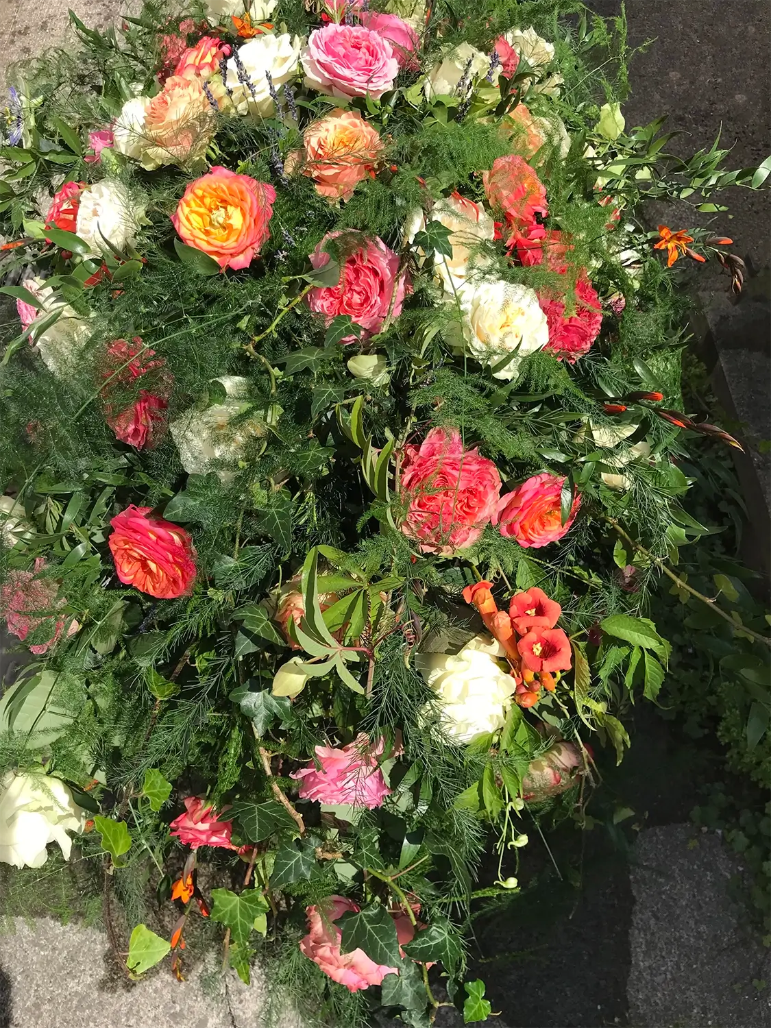 Funeral flowers orange pink white display
