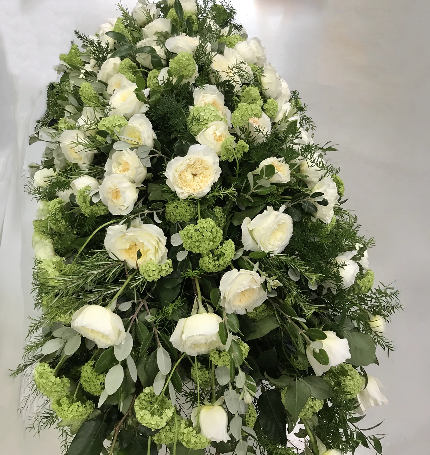 Funeral white flowers oval display